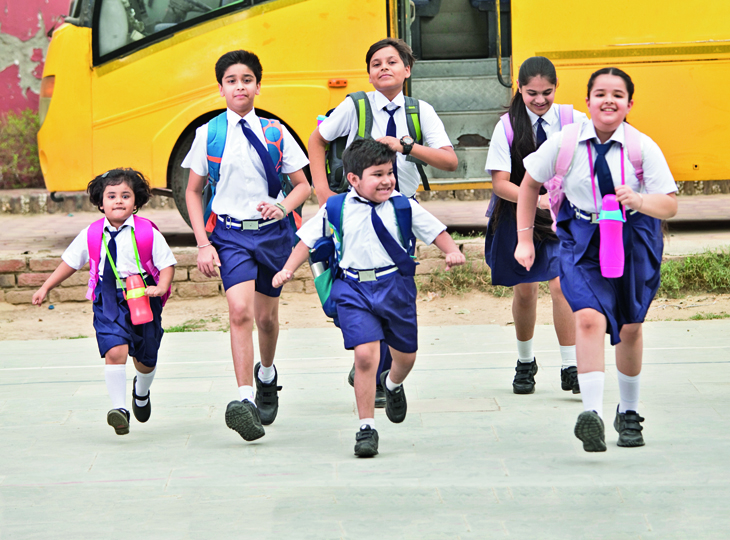 Schoolboys and schoolgirls walking of the school bus